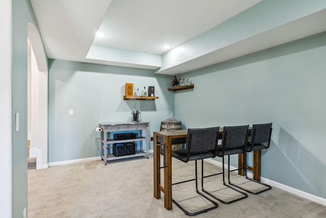 home office with recessed lighting, light carpet, a dry bar, and baseboards