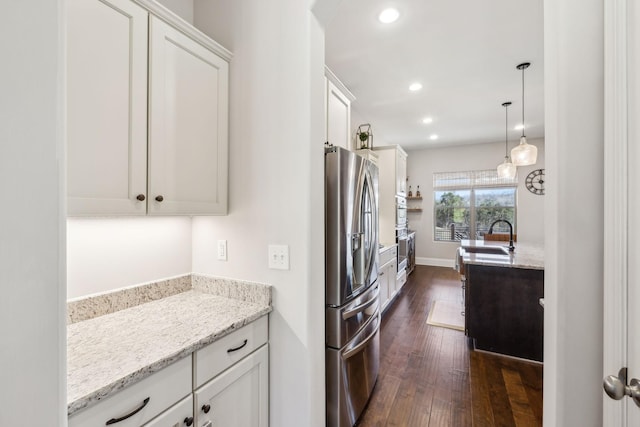 kitchen with recessed lighting, a sink, white cabinetry, stainless steel fridge with ice dispenser, and dark wood finished floors