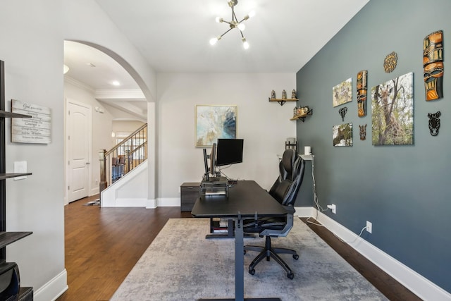 office with a notable chandelier, baseboards, arched walkways, and wood finished floors