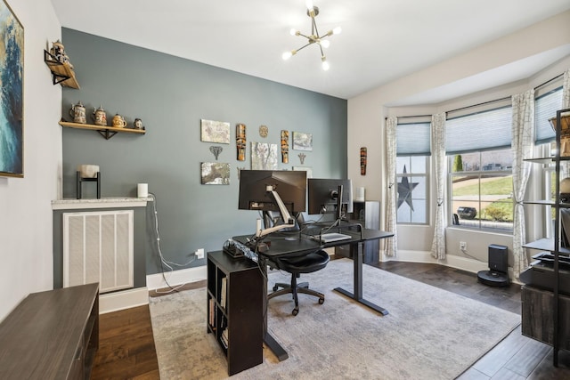 office area featuring visible vents, a notable chandelier, baseboards, and wood finished floors