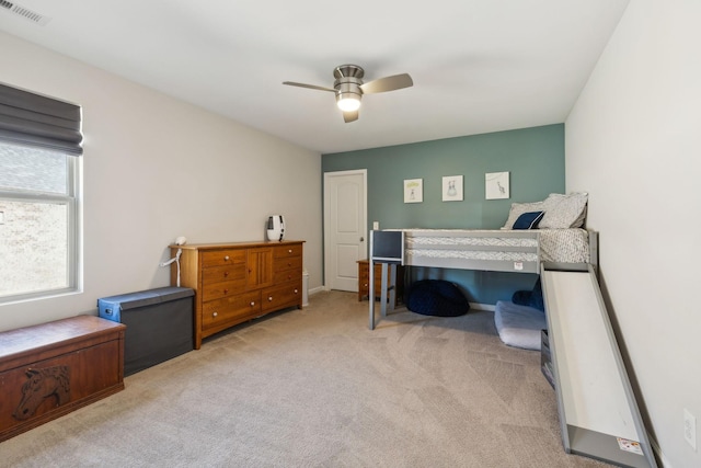 carpeted bedroom with ceiling fan and visible vents