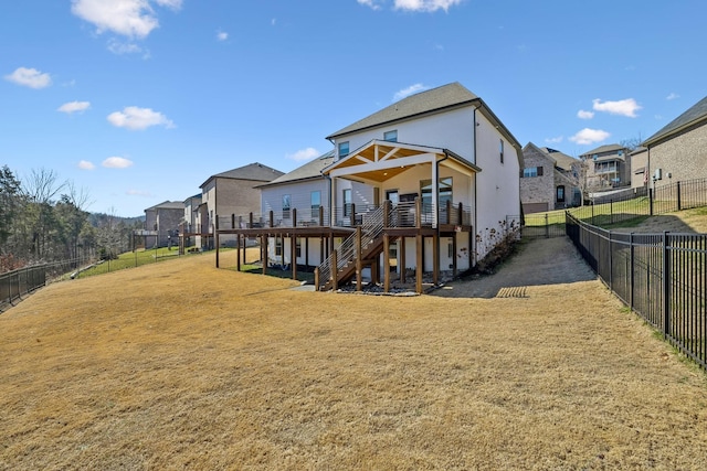 rear view of house featuring stairs, a yard, a deck, and fence private yard