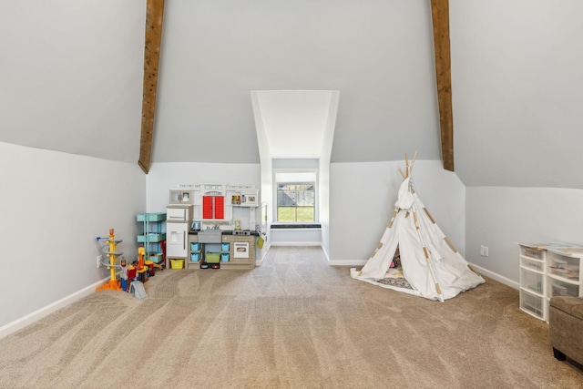 playroom featuring carpet flooring, vaulted ceiling with beams, and baseboards