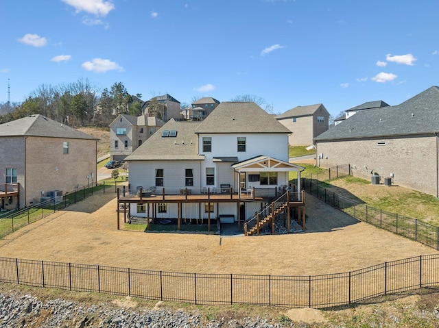 back of property with a yard, stairway, a wooden deck, and a residential view