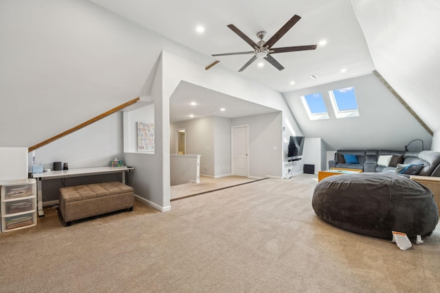 interior space featuring carpet, recessed lighting, lofted ceiling with skylight, a ceiling fan, and baseboards