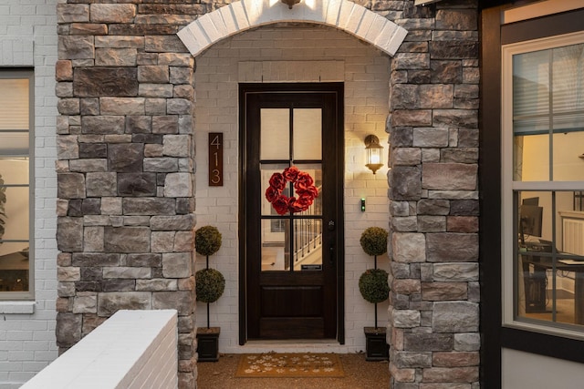 entrance to property with stone siding