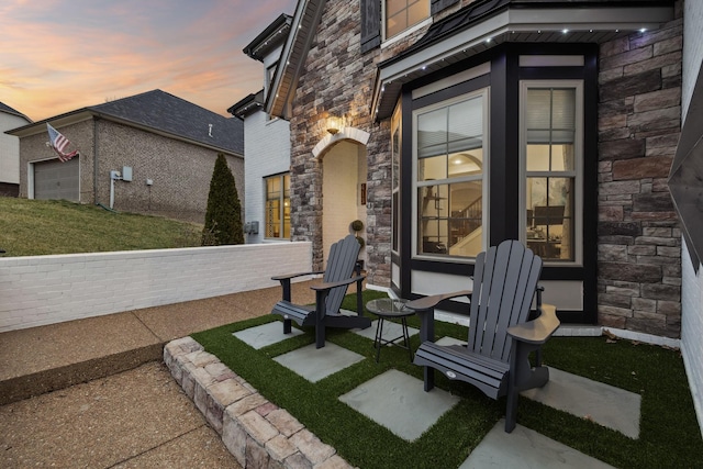 view of patio terrace at dusk