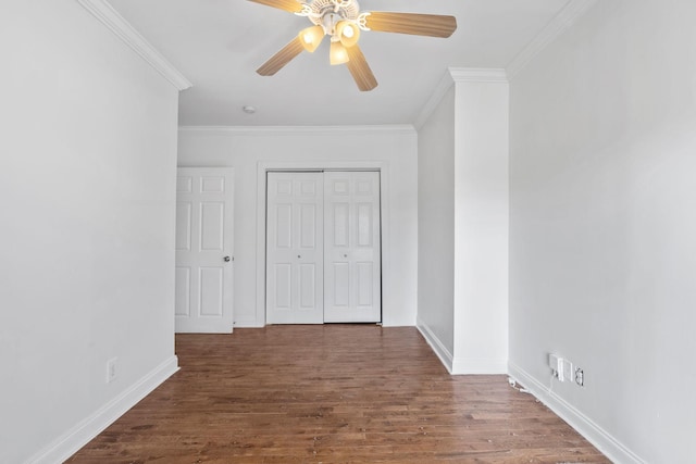 unfurnished room with ornamental molding, wood finished floors, a ceiling fan, and baseboards