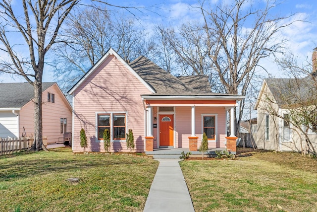 view of front of house with a front yard and fence