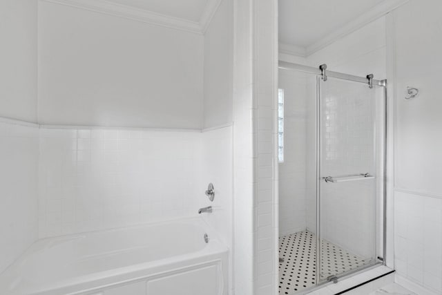 bathroom featuring ornamental molding, a stall shower, and a bath