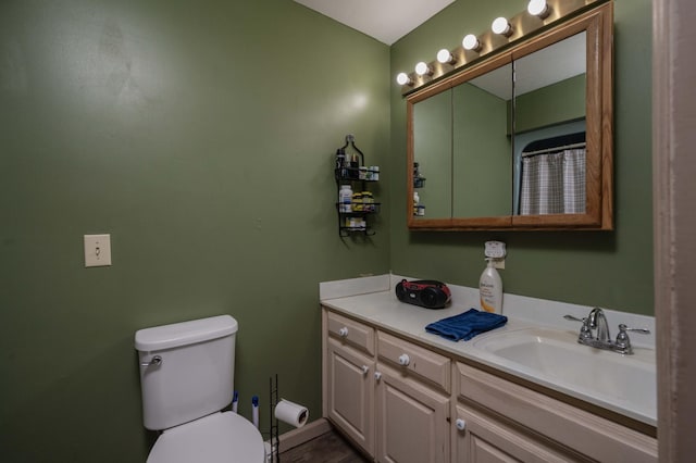 bathroom featuring vanity and toilet