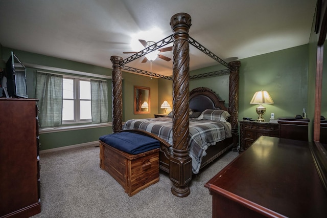 bedroom with a ceiling fan, baseboards, and carpet flooring