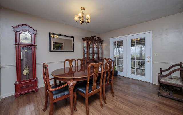 dining room with a notable chandelier and wood finished floors