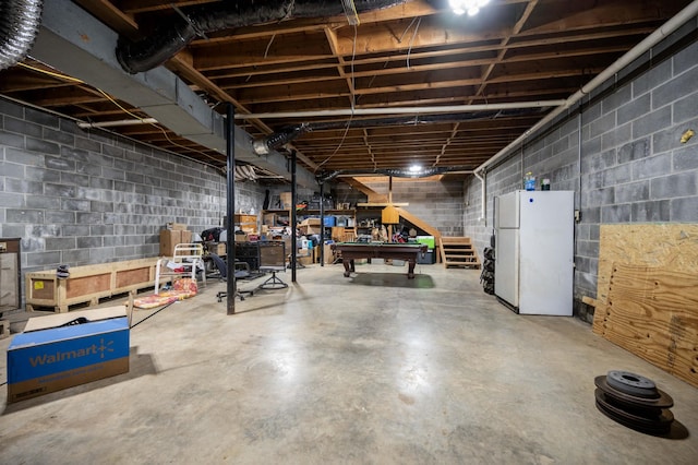 unfinished below grade area with pool table and freestanding refrigerator