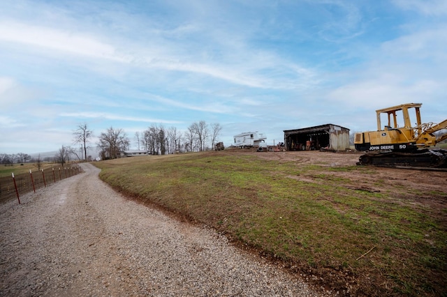 view of road with a pole building, a rural view, and gravel driveway