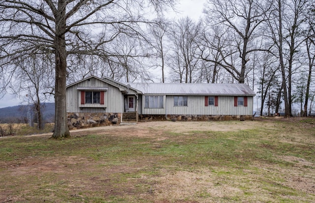 view of front of home with entry steps and metal roof