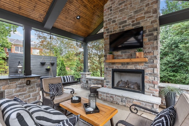 view of patio with an outdoor living space with a fireplace