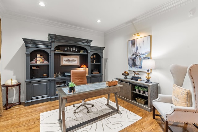 office space featuring baseboards, recessed lighting, light wood-type flooring, and crown molding