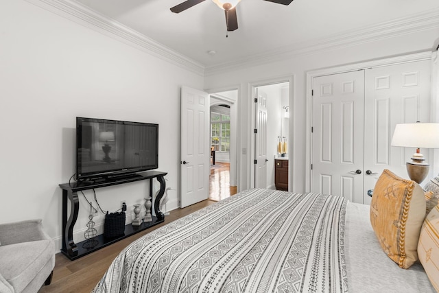 bedroom with crown molding, a closet, a ceiling fan, and wood finished floors