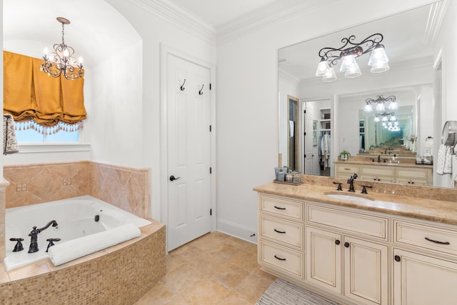 bathroom featuring ornamental molding, a whirlpool tub, a notable chandelier, vanity, and a closet