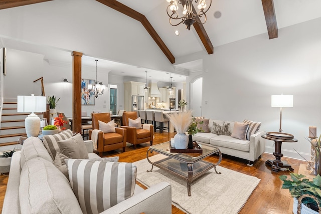 living area with a chandelier, light wood-type flooring, beamed ceiling, and high vaulted ceiling