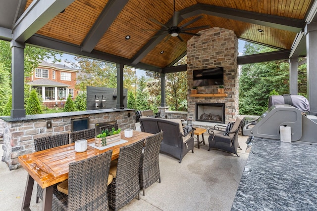 view of patio with a ceiling fan, outdoor dining area, a gazebo, and an outdoor living space with a fireplace