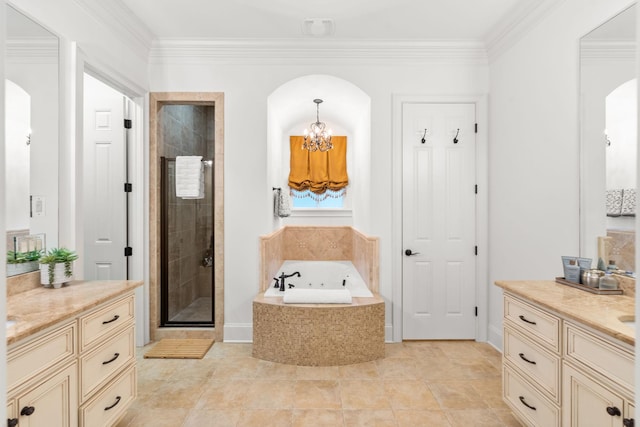 bathroom with a stall shower, ornamental molding, a garden tub, vanity, and a notable chandelier