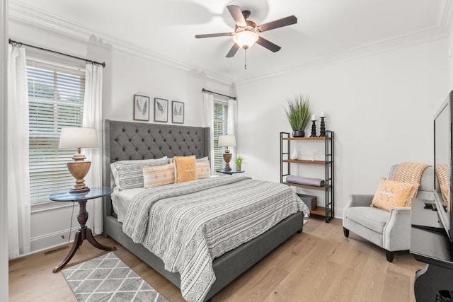 bedroom featuring ornamental molding, multiple windows, wood finished floors, and visible vents