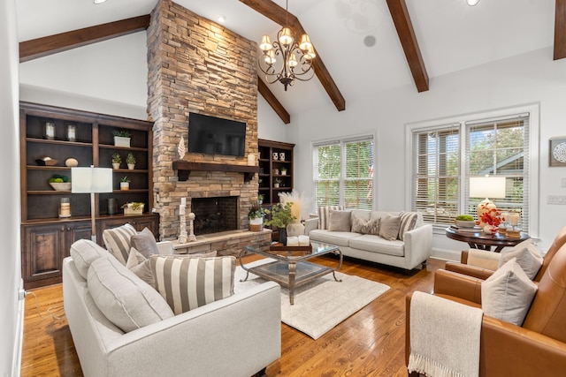 living room featuring beamed ceiling, wood finished floors, a fireplace, high vaulted ceiling, and a notable chandelier