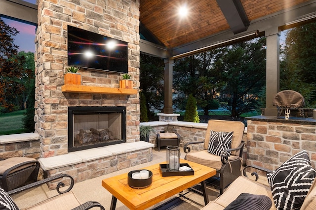 view of patio / terrace featuring an outdoor stone fireplace