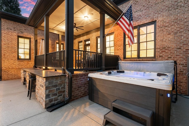 patio terrace at dusk with a hot tub