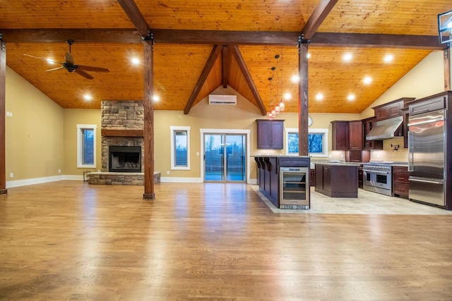 kitchen with wine cooler, wood ceiling, open floor plan, high quality appliances, and under cabinet range hood