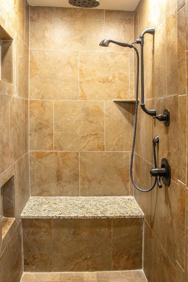 bathroom with tiled shower