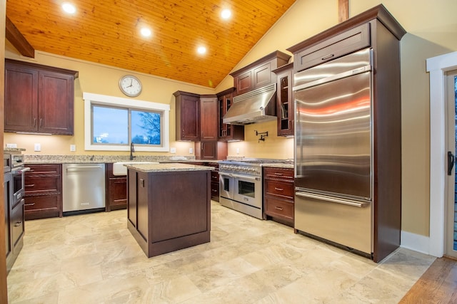 kitchen with light stone counters, wooden ceiling, under cabinet range hood, a sink, and high end appliances