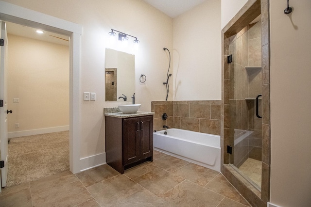 full bathroom with a tub, a shower stall, baseboards, and vanity