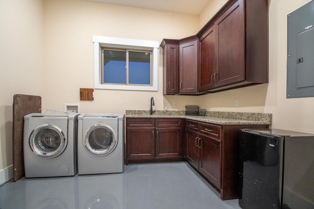 laundry room featuring cabinet space, electric panel, a sink, and washer and clothes dryer