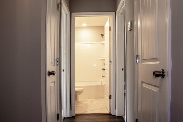 corridor featuring marble finish floor