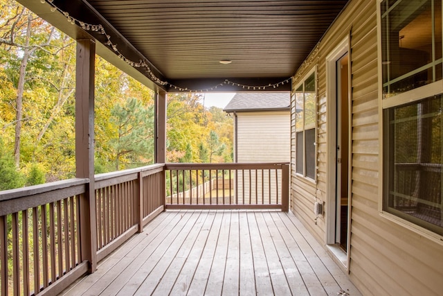 wooden terrace featuring a forest view