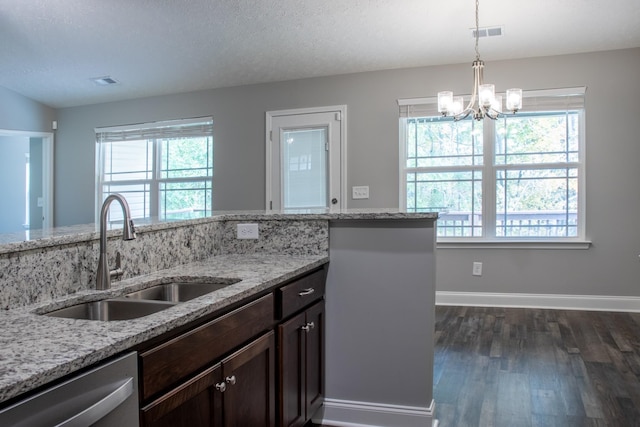 kitchen featuring dark brown cabinetry, visible vents, dark wood finished floors, dishwasher, and a sink