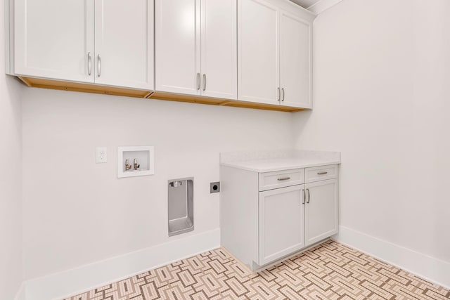 laundry area with hookup for a washing machine, cabinet space, electric dryer hookup, and baseboards