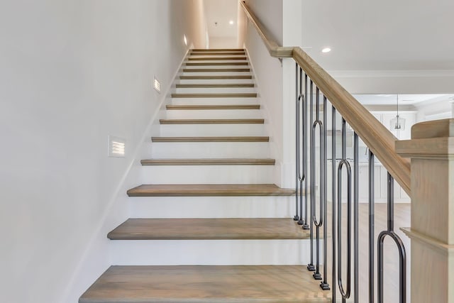 stairs featuring recessed lighting and crown molding