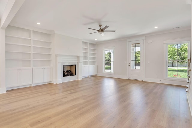 unfurnished living room with recessed lighting, a premium fireplace, a ceiling fan, light wood-type flooring, and baseboards