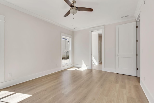 unfurnished bedroom with crown molding, visible vents, light wood-style floors, ceiling fan, and baseboards