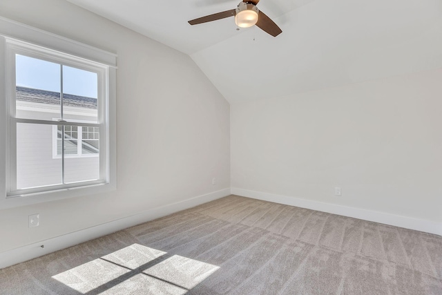 bonus room with lofted ceiling, carpet floors, a ceiling fan, and baseboards