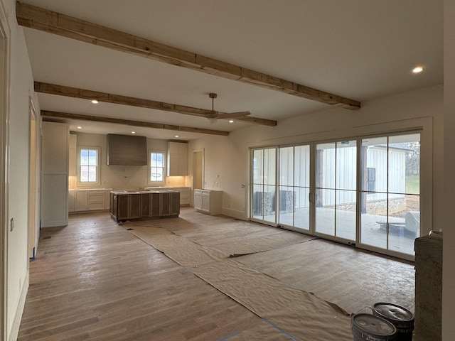 kitchen featuring light wood-type flooring, a kitchen island, beam ceiling, and recessed lighting