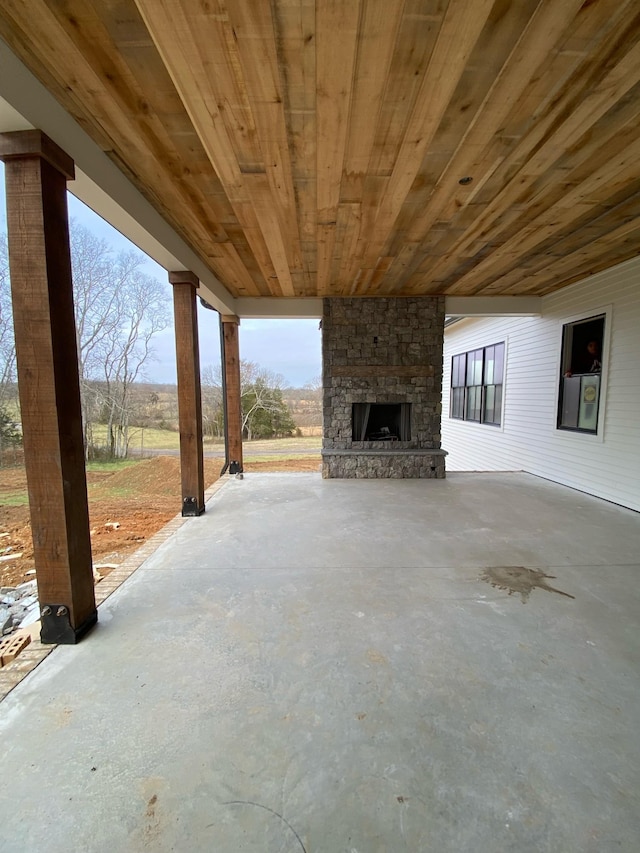 view of patio with an outdoor stone fireplace