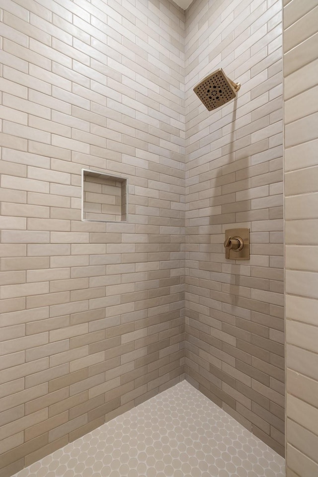 bathroom with tiled shower