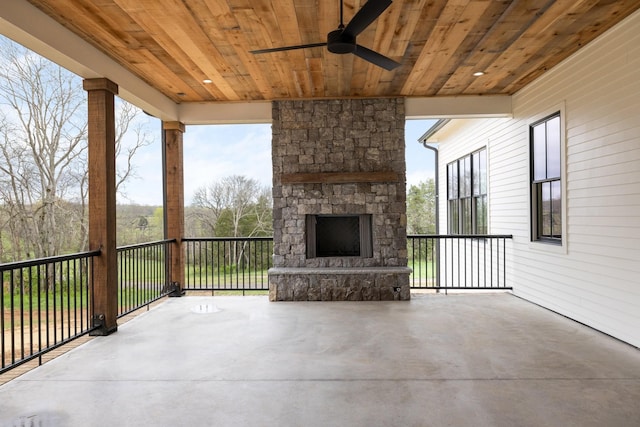 view of patio / terrace featuring an outdoor stone fireplace and ceiling fan