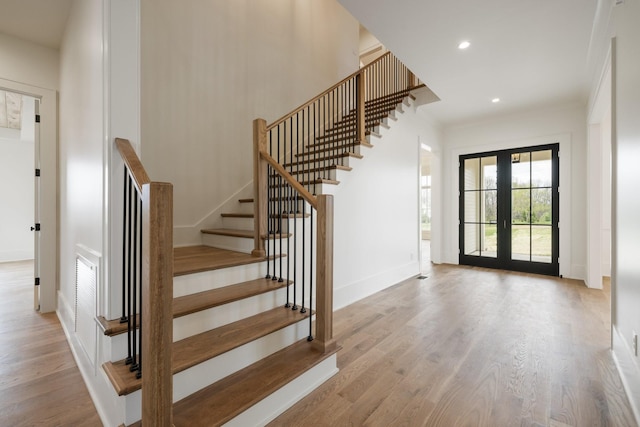 interior space with baseboards, wood finished floors, and recessed lighting