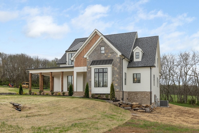 view of front of property with covered porch, a front yard, a standing seam roof, a shingled roof, and cooling unit
